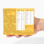 Hand holding a supplement package with detailed nutritional information on a white background